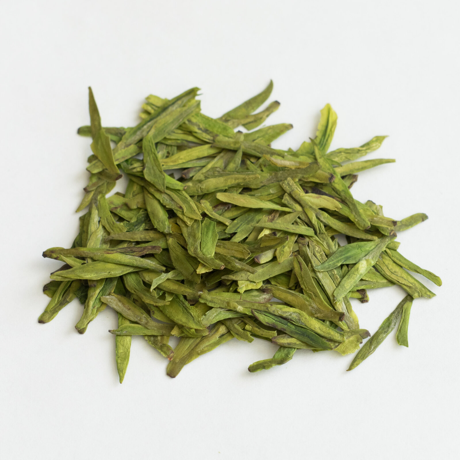 Longjing green tea — leaves and liquor tied to Hangzhou hills and gongfu pacing